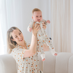 Baby wearing the ZIPSTER x Miffy Checkered Bloom bamboo babygrow