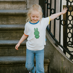 Child wearing the White Miffy children's T-shirt with green Miffy print