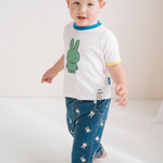 Child wearing the White Miffy children's T-shirt with green Miffy print