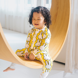 Baby wearing the ZIPSTER x Miffy Hello Yellow bamboo babygrow