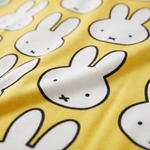 Close-up of the soft bamboo fabric of the ZIPSTER x Miffy Hello Yellow bamboo babygrow